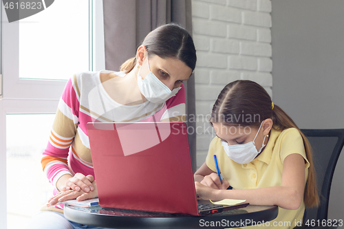 Image of Mom and daughter jointly understand online services for distance learning