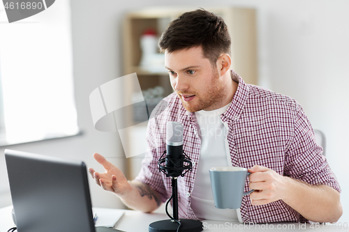 Image of blogger with laptop and microphone audio blogging