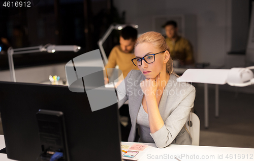 Image of tired businesswoman working at night office