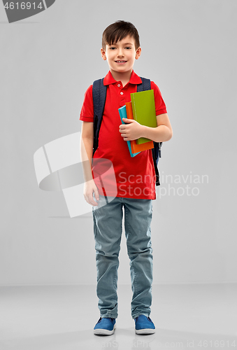 Image of smiling student boy with books and school bag