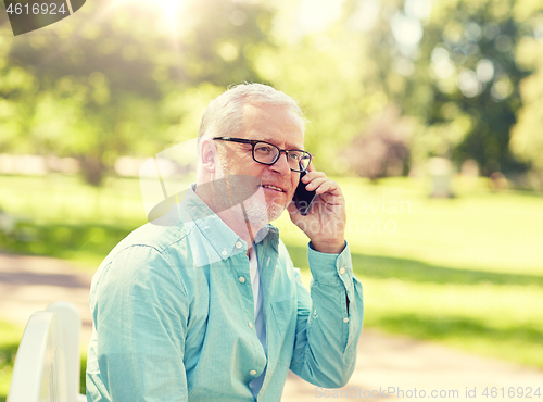 Image of senior man calling on smartphone at summer park