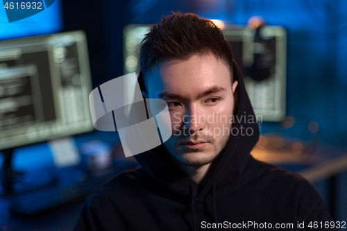 Image of asian hacker in dark room with computers at night