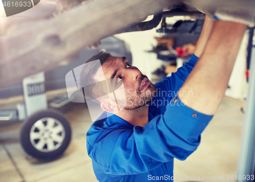 Image of mechanic man or smith repairing car at workshop