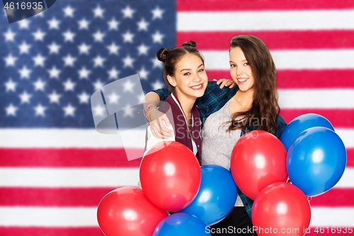 Image of teenage girls with balloons over american flag