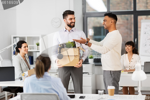 Image of new male employee meeting colleagues at office