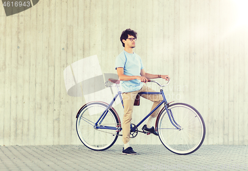 Image of young hipster man riding fixed gear bike