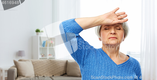 Image of tired senior woman suffering from headache