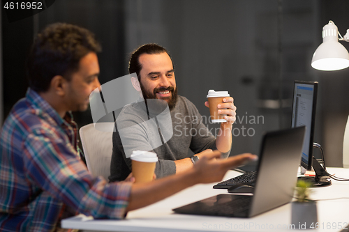 Image of creative team drinking coffee at night office