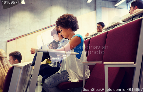 Image of group of students with notebooks at lecture hall