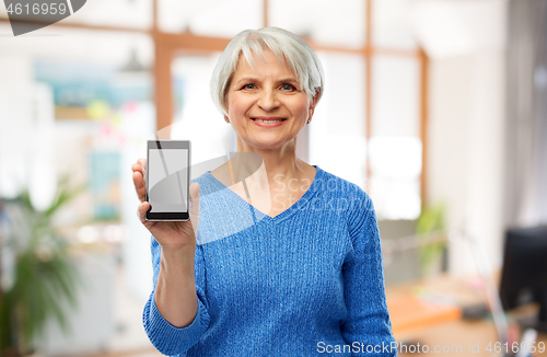 Image of smiling senior woman showing smartphone