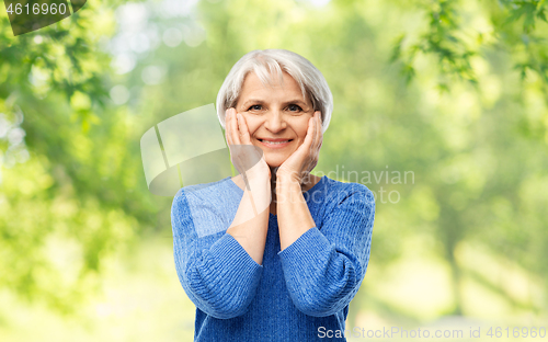 Image of portrait of smiling senior woman in blue sweater