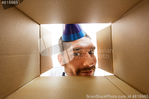 Image of happy man opening parcel box or birthday gift