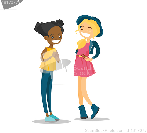 Image of Two young multiracial girls talking and laughing.