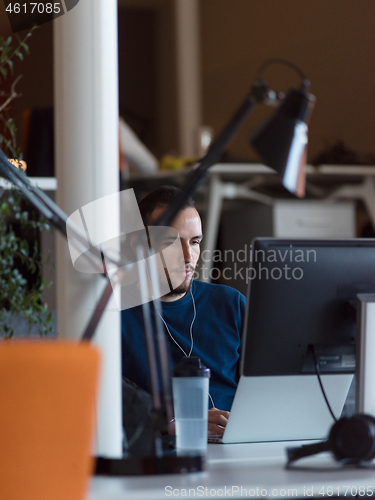 Image of businessman working using a laptop in startup office