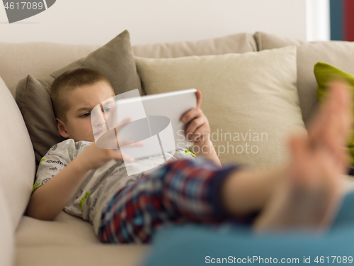 Image of little boy playing games on tablet computers