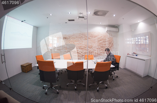 Image of businessman working using a laptop in startup office