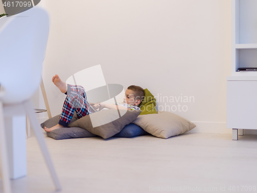 Image of little boy playing games on tablet computers