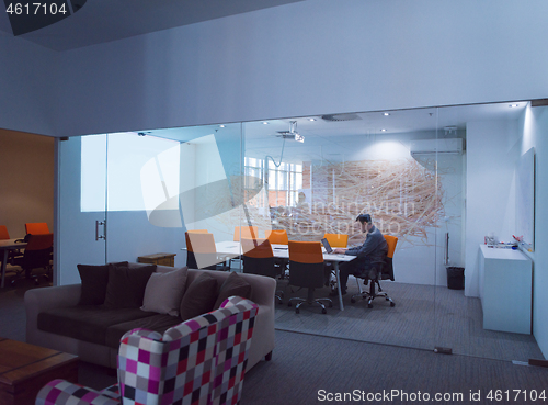 Image of businessman working using a laptop in startup office