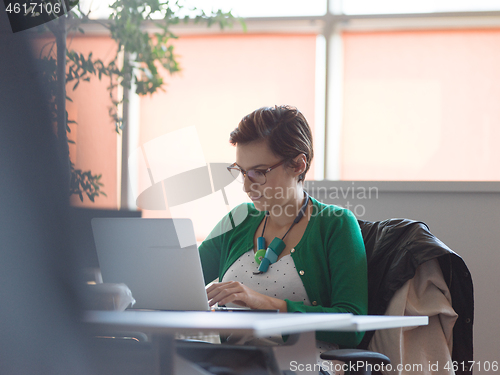 Image of businesswoman using a laptop in startup office