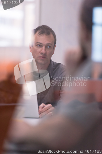 Image of businessman working using a laptop in startup office