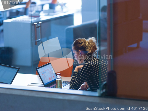 Image of businesswoman using a laptop in startup office