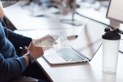 Image of businessman working using a laptop in startup office