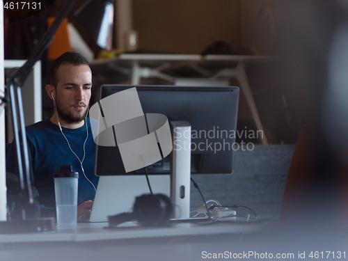 Image of businessman working using a laptop in startup office