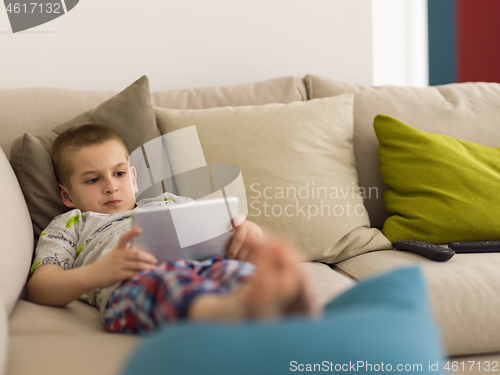 Image of little boy playing games on tablet computers