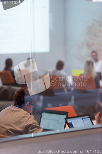 Image of businesswoman using a laptop in startup office