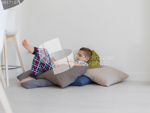 Image of little boy playing games on tablet computers