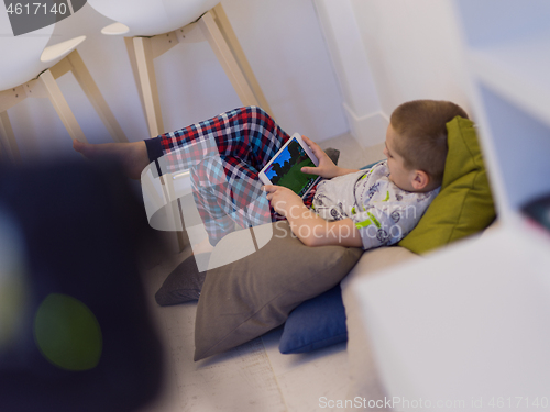 Image of little boy playing games on tablet computers