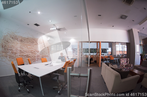 Image of businessman working using a laptop in startup office