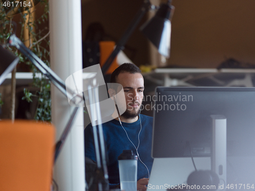 Image of businessman working using a laptop in startup office