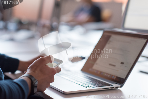 Image of businessman working using a laptop in startup office