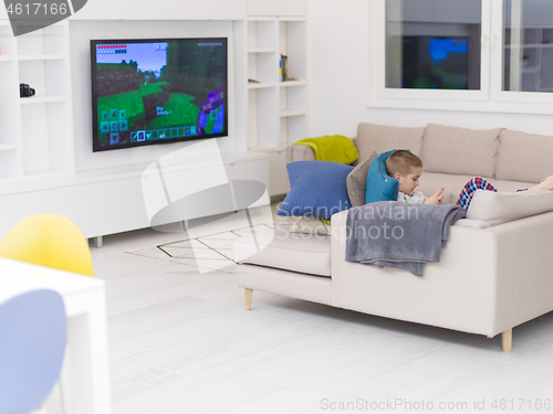 Image of little boy playing games on smartphone