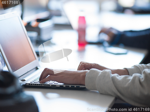 Image of businessman working using a laptop in startup office