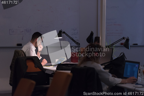 Image of businessman working using a laptop in startup office