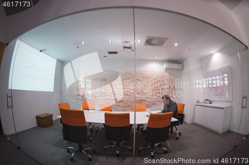 Image of businessman working using a laptop in startup office