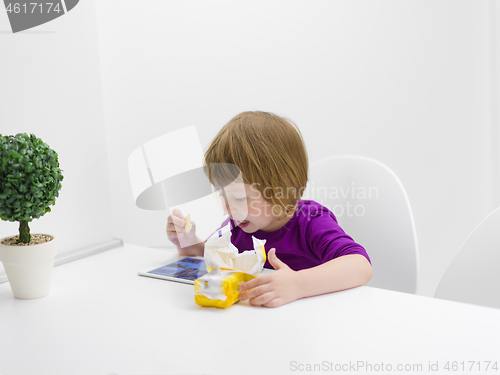 Image of little girl playing games on tablet computer