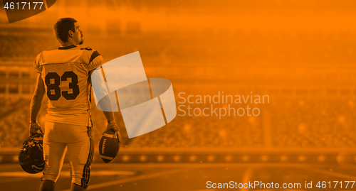 Image of duo toned american football player in  arena at night