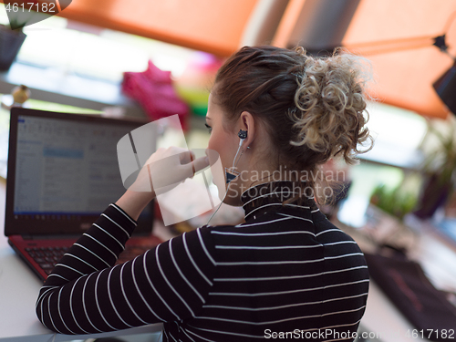 Image of businesswoman using a laptop in startup office