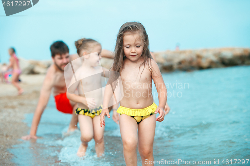Image of Two happy children playing on the beach at the day time