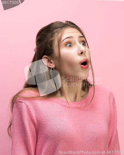 Image of The woman screaming with open mouth isolated on pink background, concept face emotion