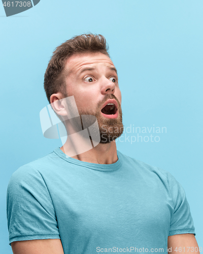 Image of The man screaming with open mouth isolated on blue background, concept face emotion