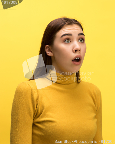 Image of The woman screaming with open mouth isolated on yellow background, concept face emotion