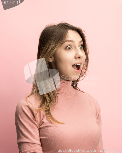 Image of The woman screaming with open mouth isolated on pink background, concept face emotion