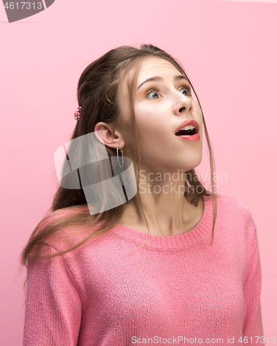 Image of The woman screaming with open mouth isolated on pink background, concept face emotion