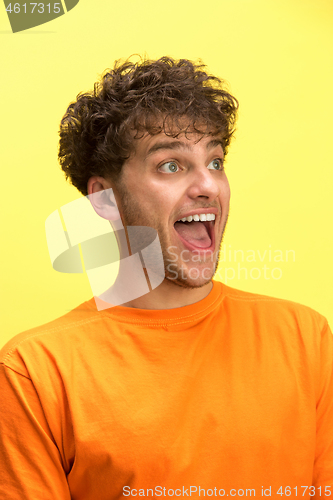 Image of The man screaming with open mouth isolated on yellow background, concept face emotion