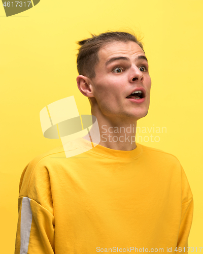 Image of The man screaming with open mouth isolated on yellow background, concept face emotion