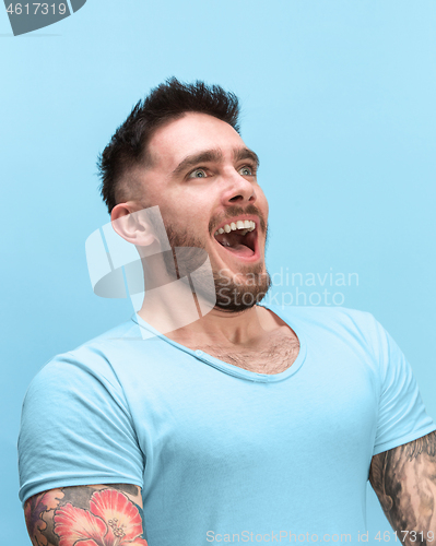 Image of The man screaming with open mouth isolated on blue background, concept face emotion